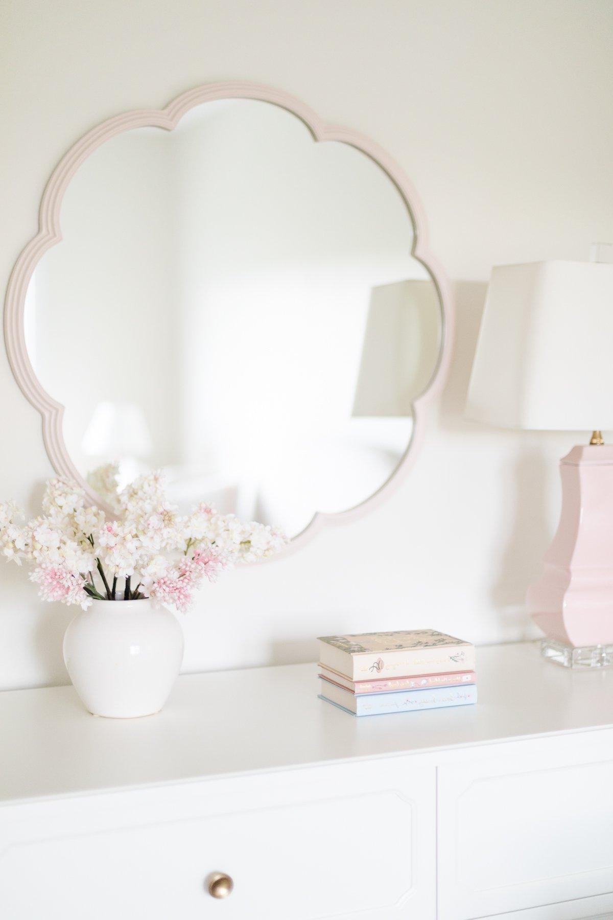 Pottery Barn Kids: Der Look zum kleinen Preis 27 Eine weiße Kommode mit einem pinken Spiegel, der den charmanten Pottery Barn Kids Look for Less abrundet.