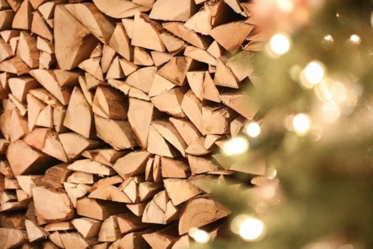 Gestapeltes Brennholz im Kamin als Teil der Weihnachtsdekoration, die später verbrannt werden kann.