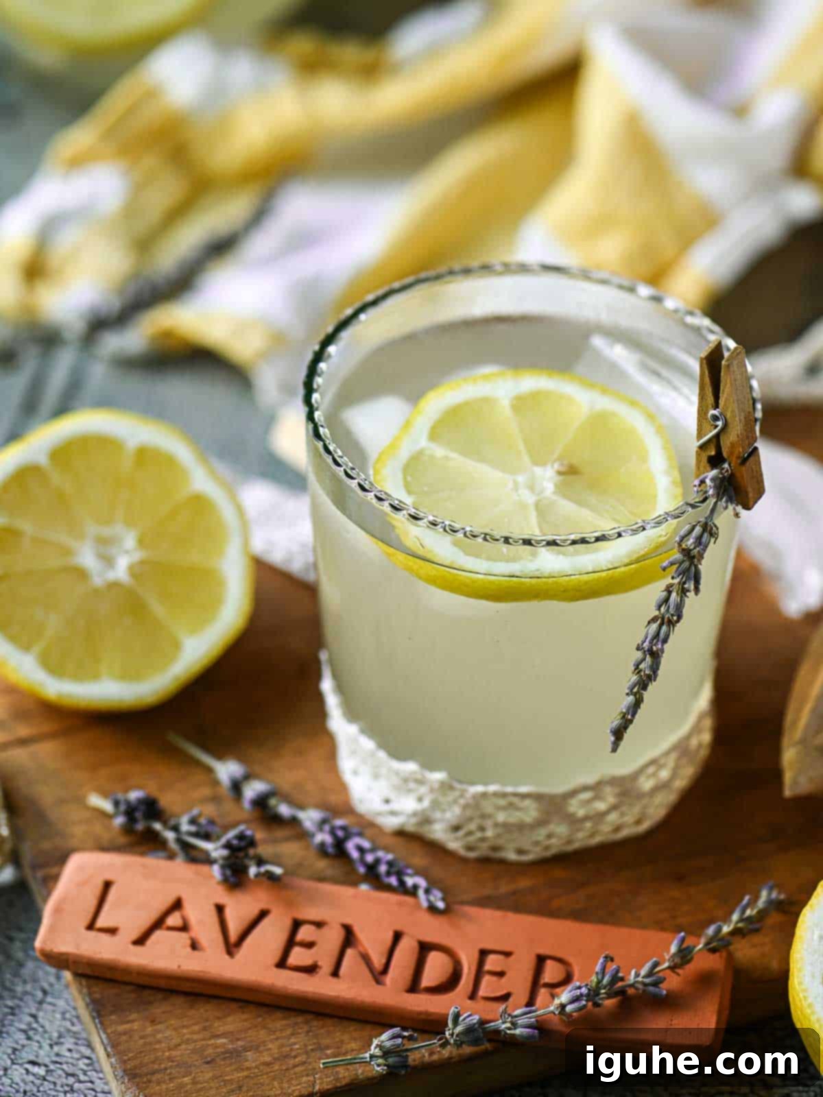 Lavender lemonade in a glass with lemon slices and lavender.