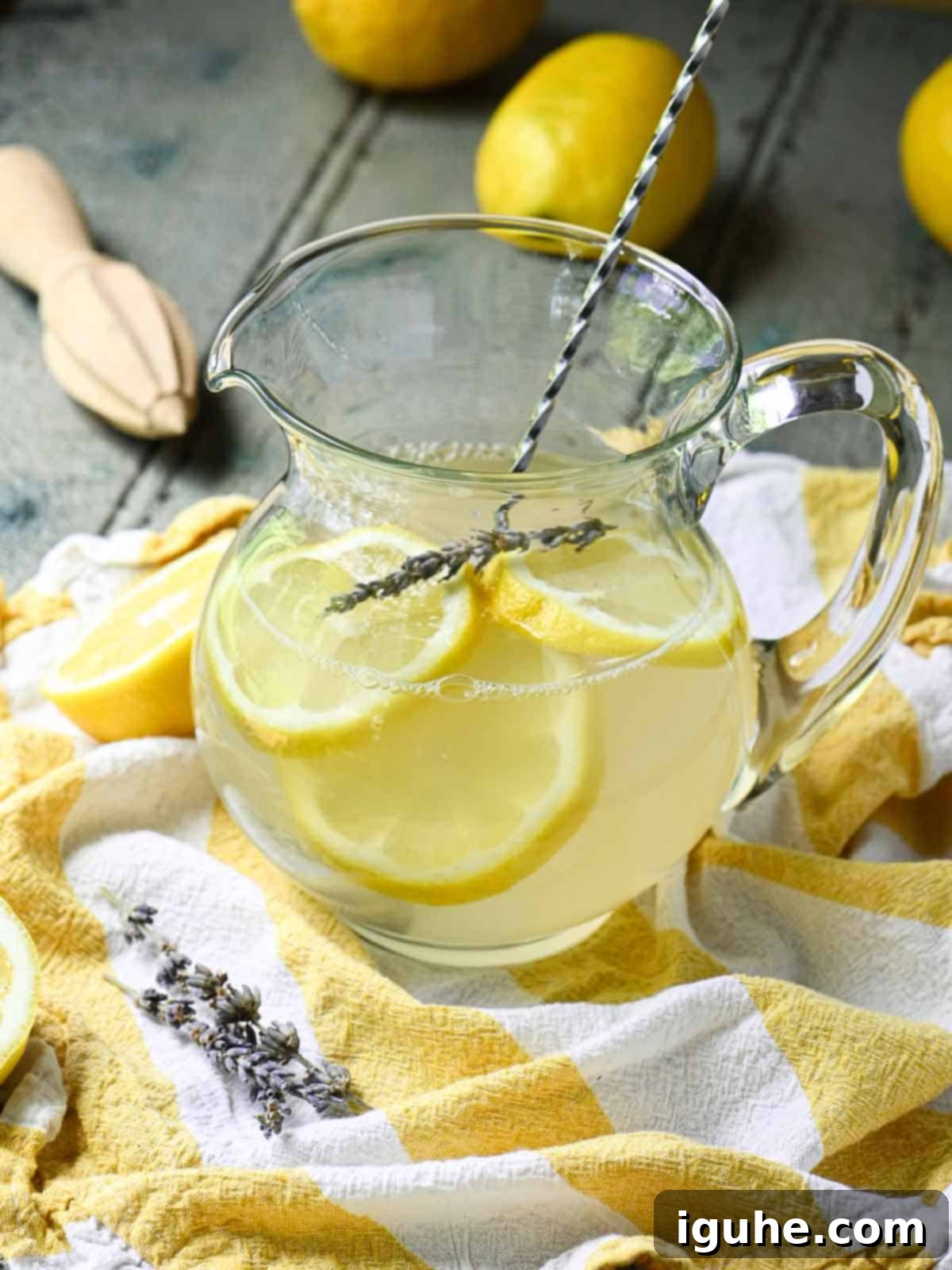 Signature Lavender Lemonade 11 Lemonade in a pitcher with a straw.