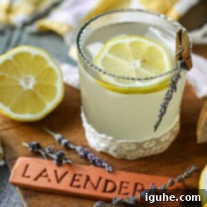 Signature Lavender Lemonade 12 Lavender lemonade in a glass with a wooden sign.