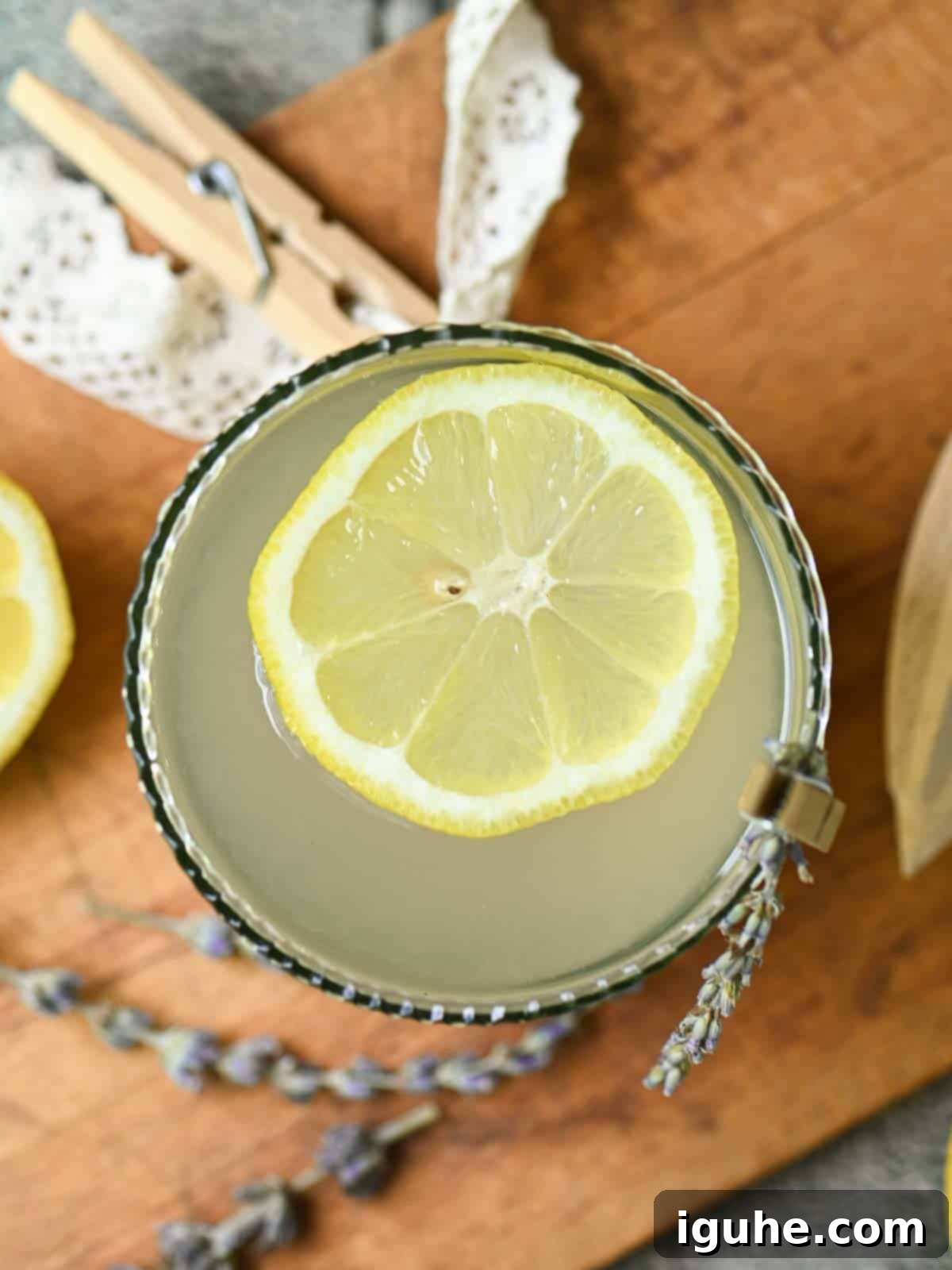 Signature Lavender Lemonade 10 Overhead of lemonade in a glass with a straw.
