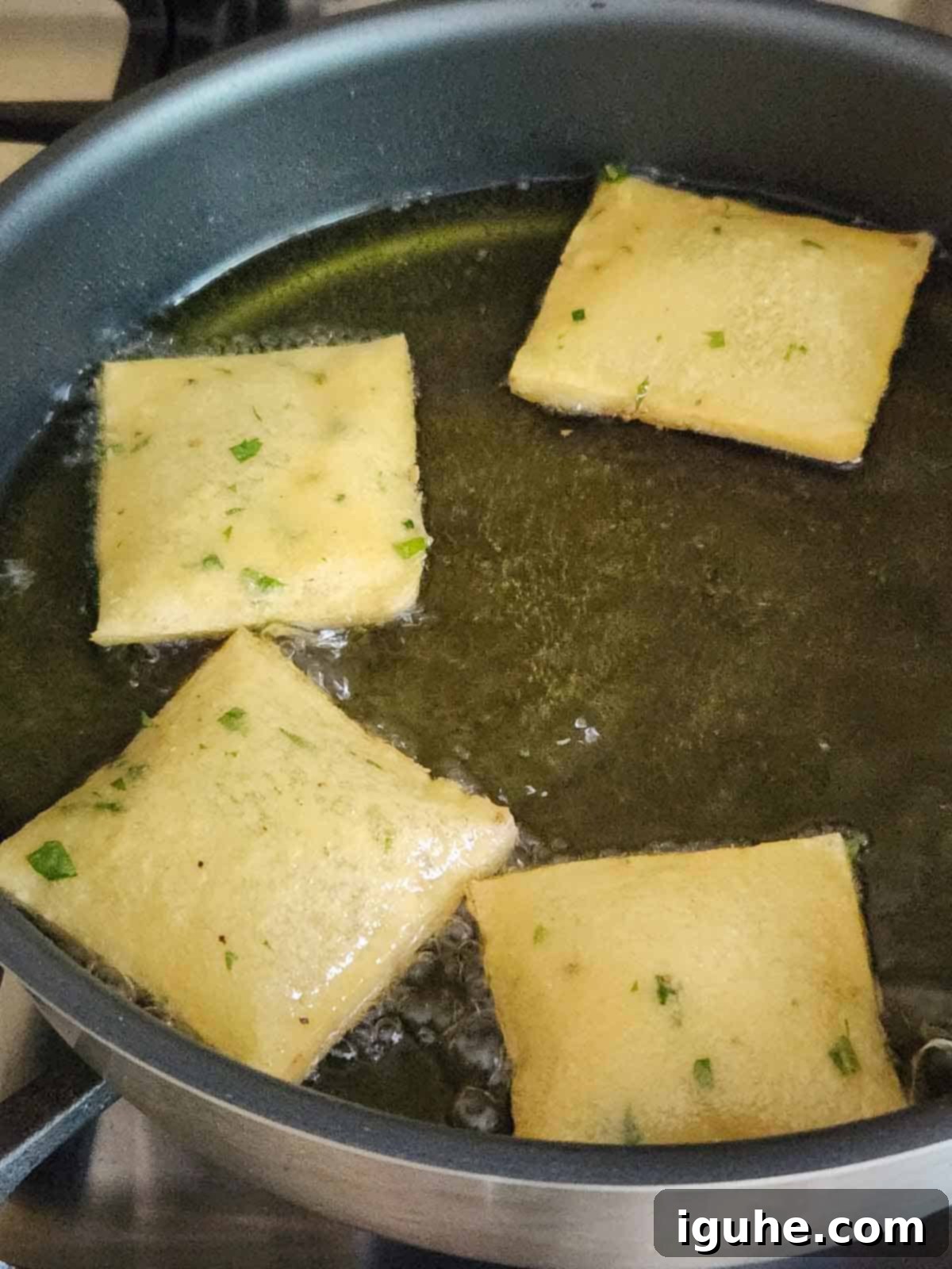 Crispy Sicilian Panelle 6 Panelle frying in a pan of oil.