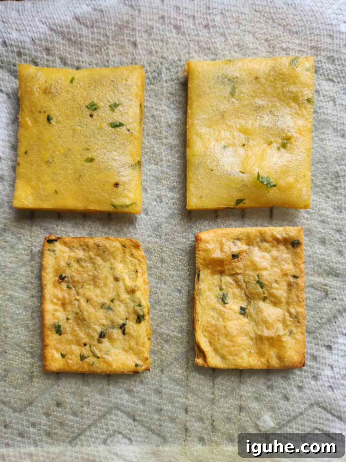 Fried panelle shown next to air-fried panelle on a paper towel.