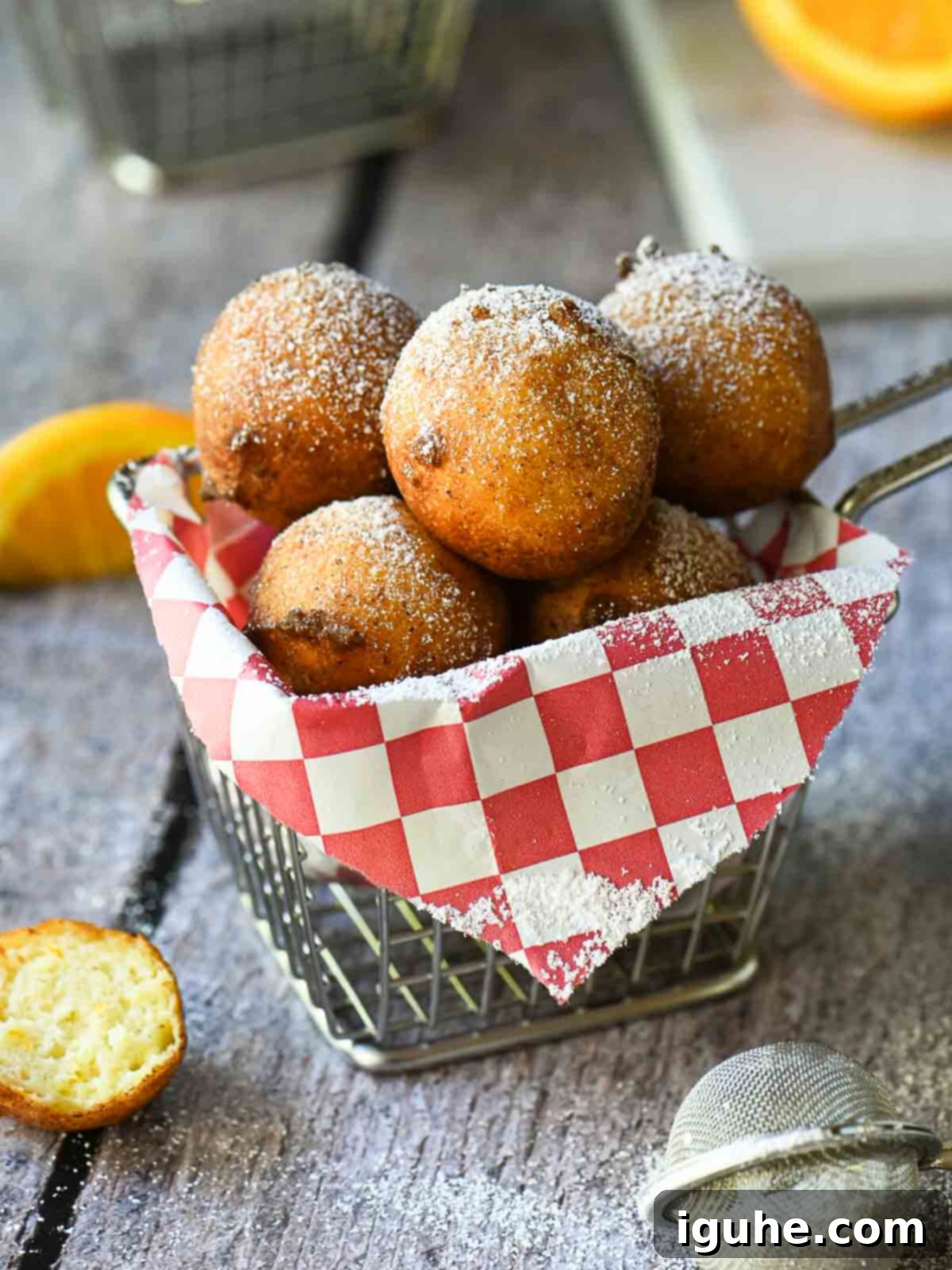 Ricotta doughnuts in a fry basket with a red checkered liner.