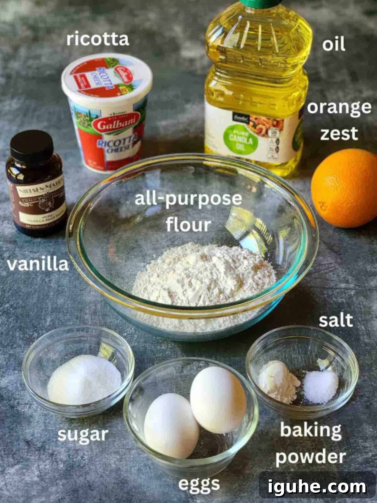 Italian Orange Ricotta Doughnuts 3 Ingredients for orange ricotta donuts on a blue surface.