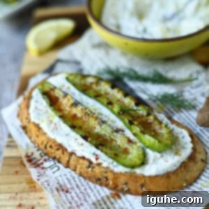 Smoky Grilled Cucumber & Tangy Tzatziki Toast 7 Grilled cucumber toast on a wood board, garnished with fresh dill.