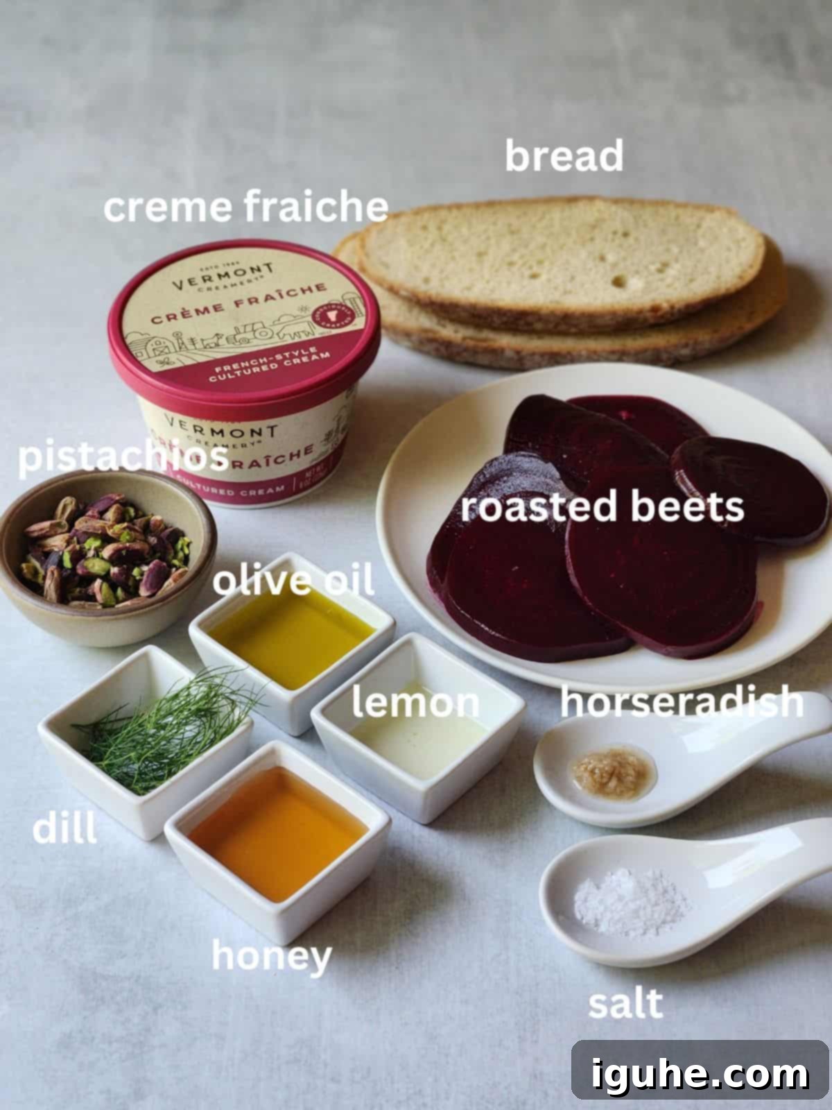 Crimson Beet Toast with Herbed Creme Fraiche 3 A flat lay of fresh beet toast ingredients on a rustic grey surface.
