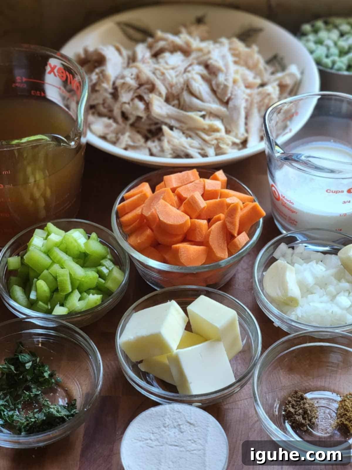 Homestyle Rotisserie Chicken Pot Pie 3 Ingredients for chicken pot pie filling in little bowls on a wood surface.
