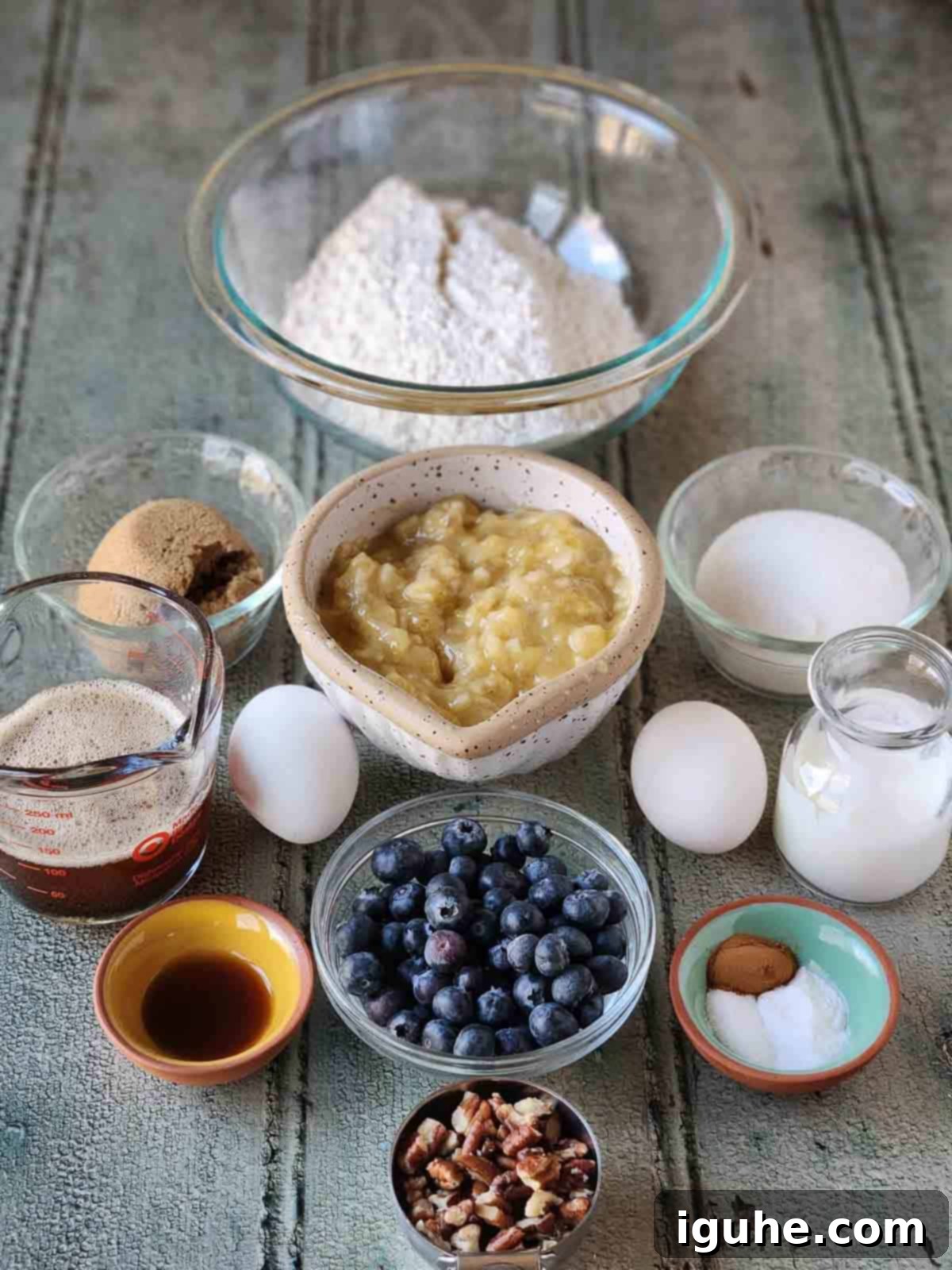 Moist Blueberry Banana Nut Bread 3 Ingredients for blueberry banana bread laid out in small bowls, ready for baking.