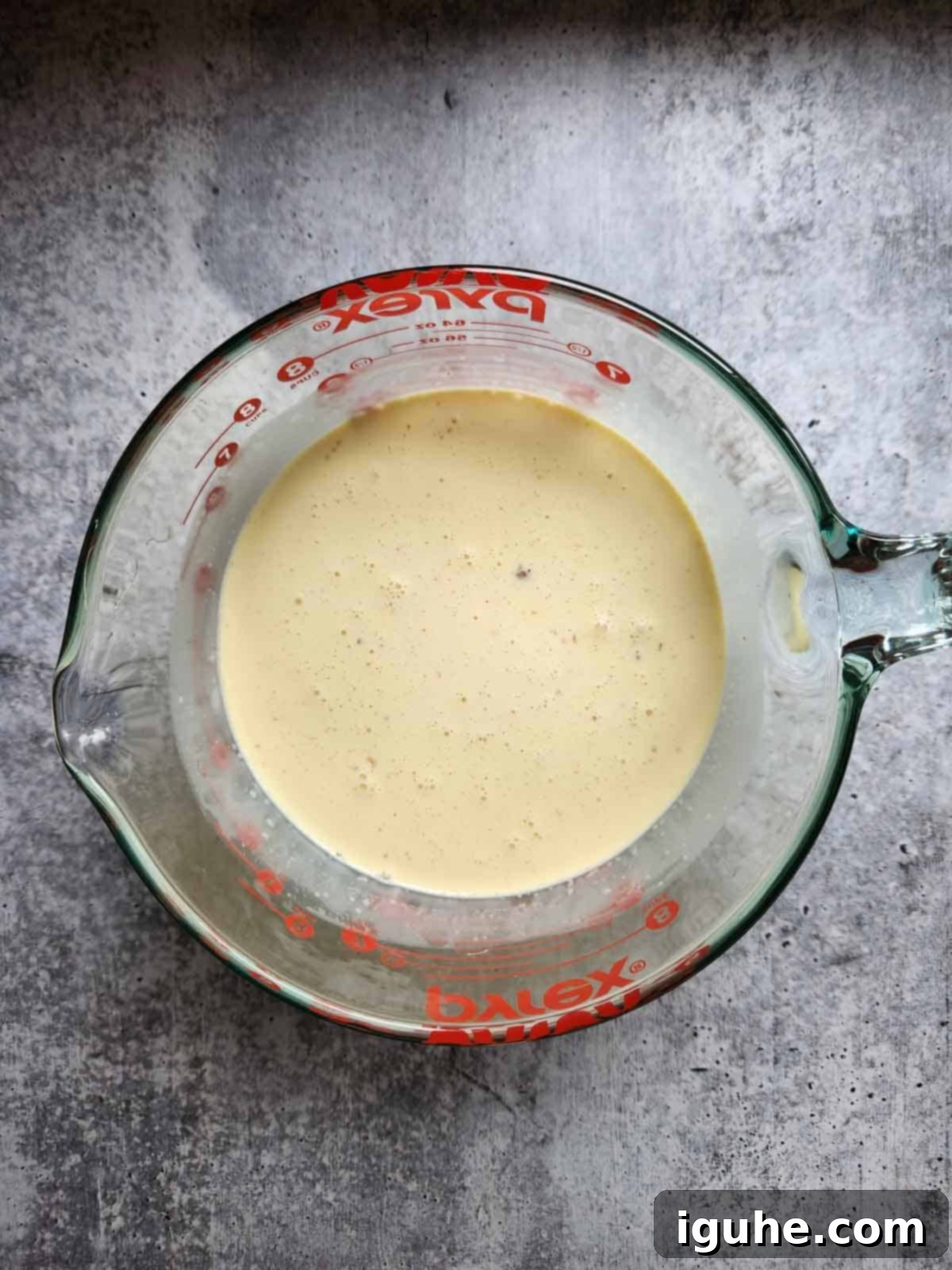 Festive Eggnog Dream Ice Cream 4 Mixed ice cream batter in a clear bowl.
