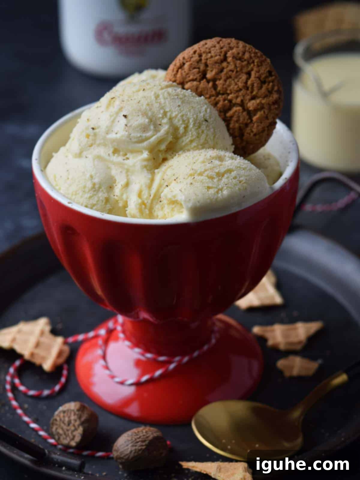 Festive Eggnog Dream Ice Cream 7 Three scoops of eggnog ice cream in a red cup with a gingersnap on top.
