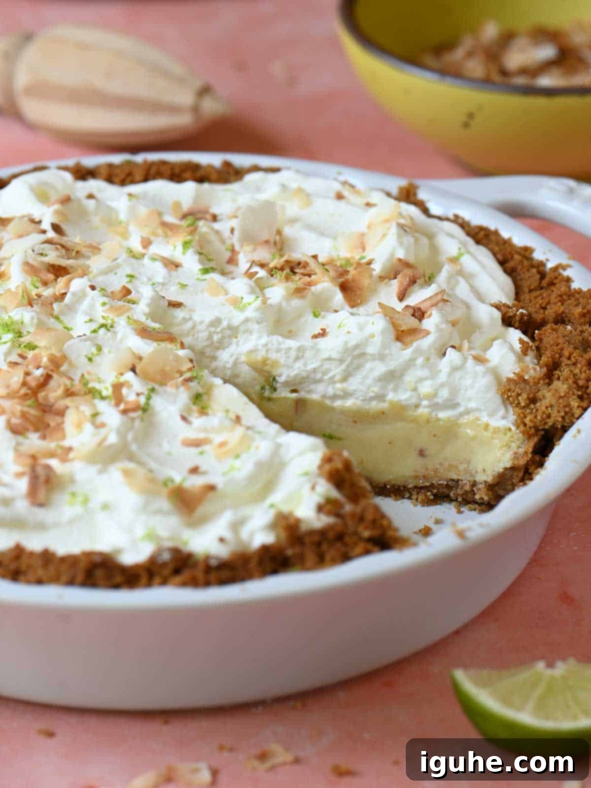 Key lime pie cut open in a pie plate to show the inside.