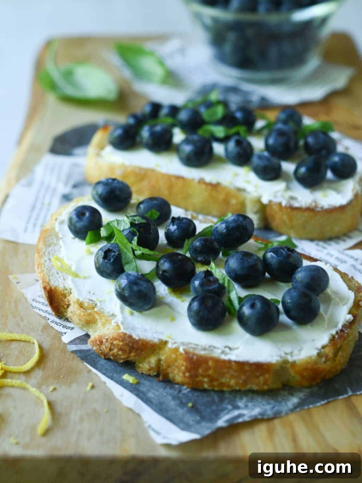 Blueberry Bliss Toast 6 Two blueberry toasts on a wood board.