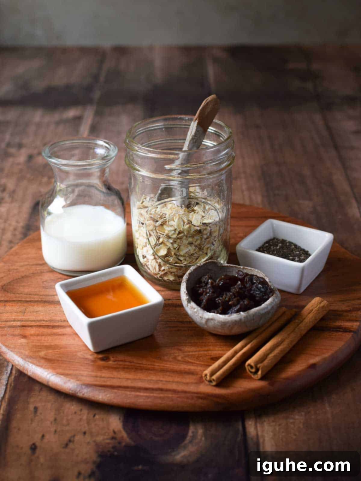 Creamy Maple Raisin Overnight Oats 3 Ingredients for overnight oats on a wooden serving board.
