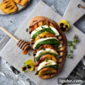 Caprese Toast with Grilled Peaches 6 Overhead view of toast with grilled peaches on it layered with mozzerella, basil and balsamic vinegar on a grey cutting board