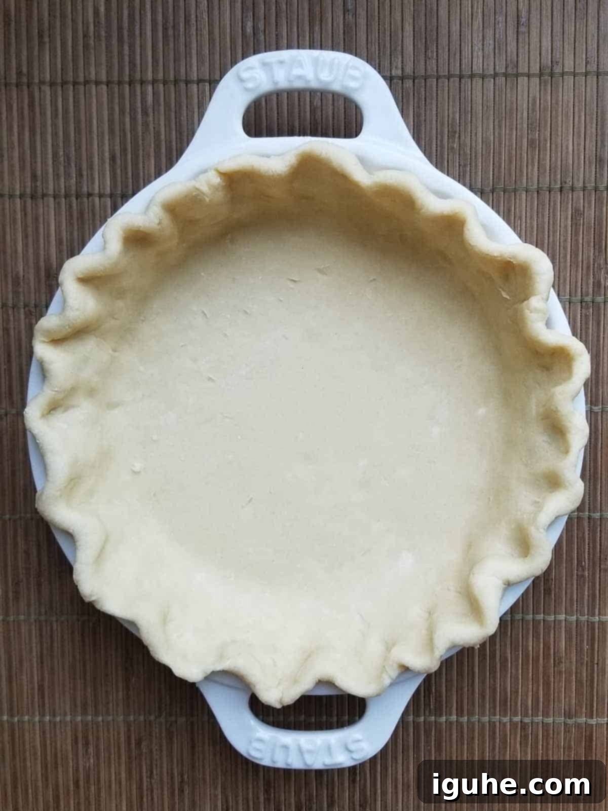 Sun-Kissed Tomato Feta Leek Quiche 5 Unbaked pie dough crimped in a pie plate