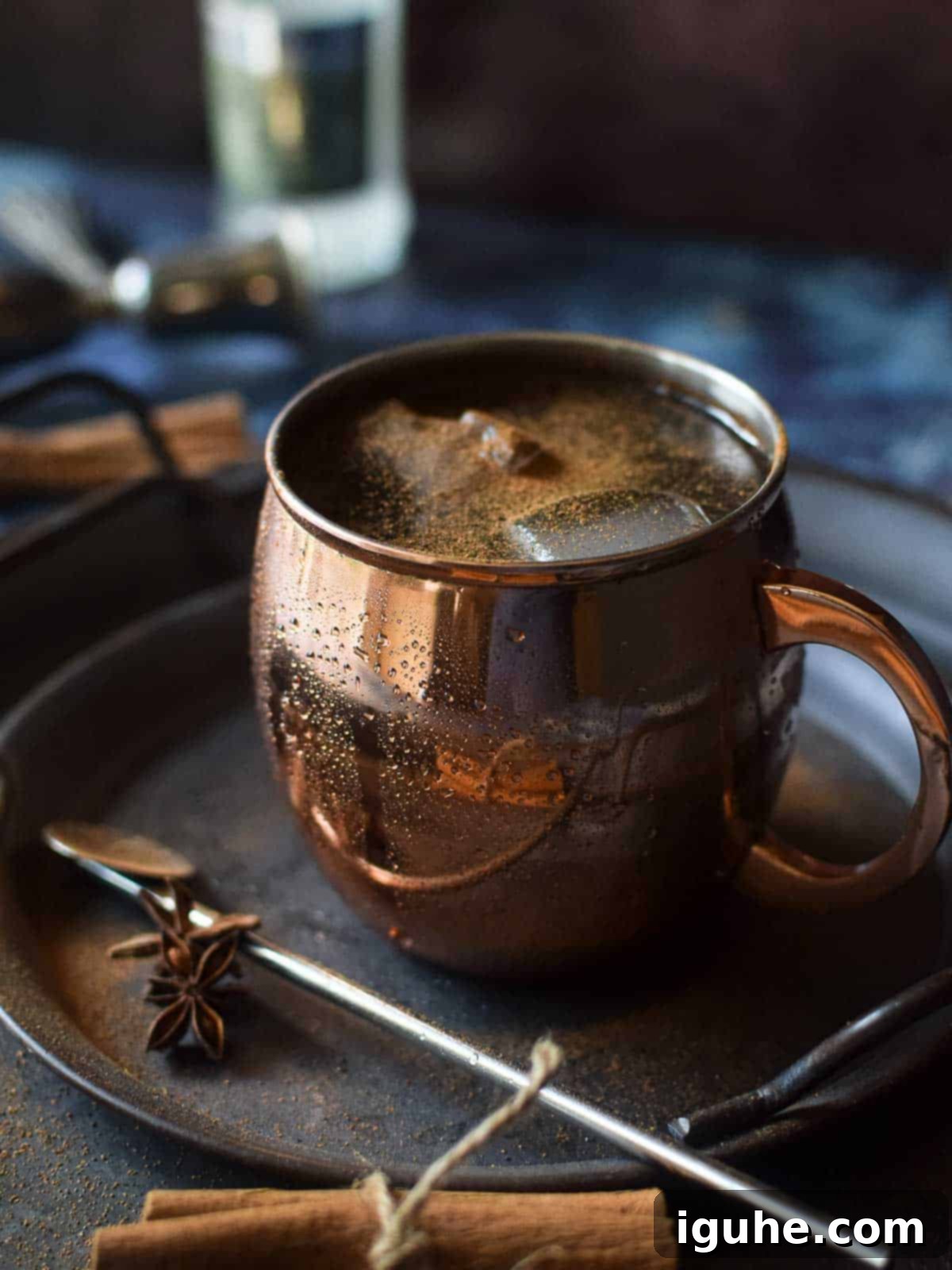 Caramelized Cinnamon Chai Mule 3 Close up of chai moscow mule in a copper mug with cinnamon stick and whole anie.