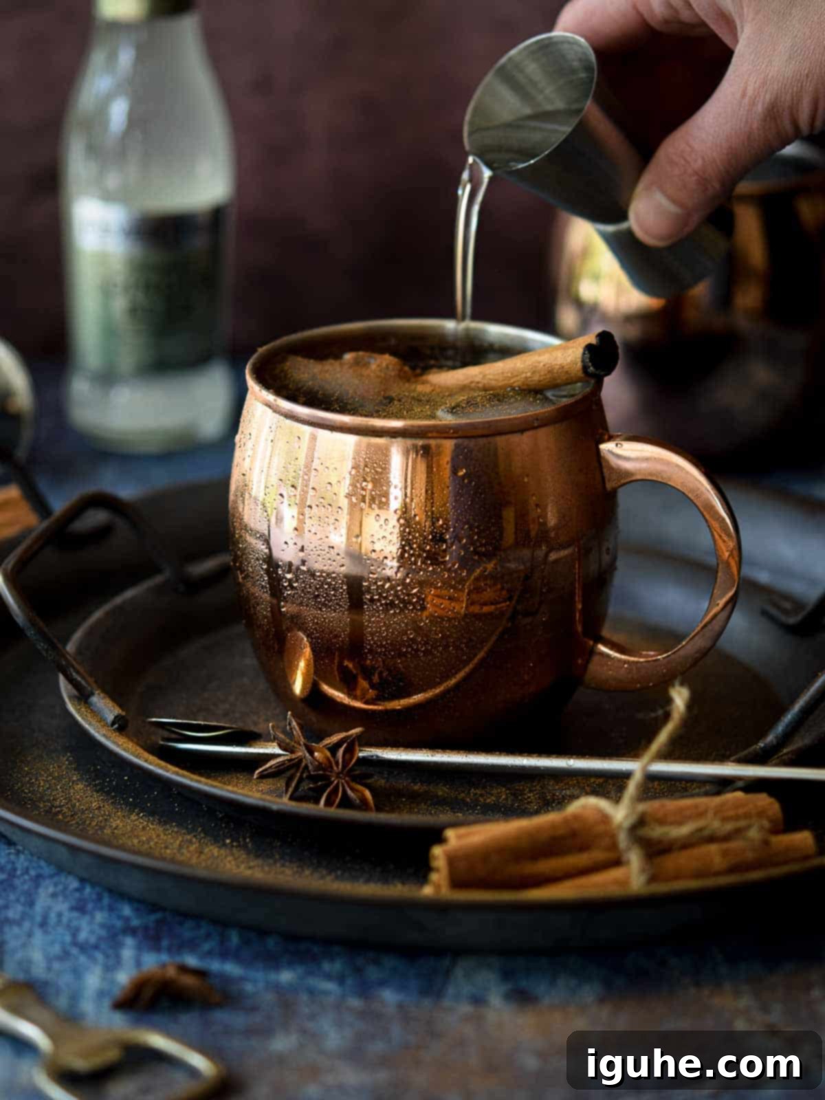 Caramelized Cinnamon Chai Mule 4 Chai Moscow mule in a copper mug with vodka being poured in.