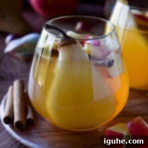 Autumn Orchard White Sangria 5 Close-up of apple and pear sangria in a glass.