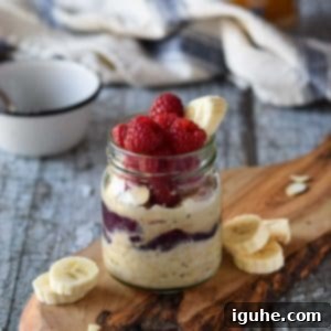 Protein-Packed PB2 Overnight Oats 5 Peanut butter overnight oats in a jar with raspberries and bananas.