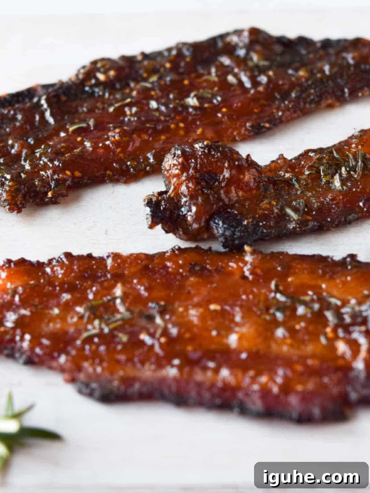 Sweet & Savory Fig-Rosemary Bacon 6 Close-up of perfectly caramelized rosemary and fig candied bacon, ready to be enjoyed.