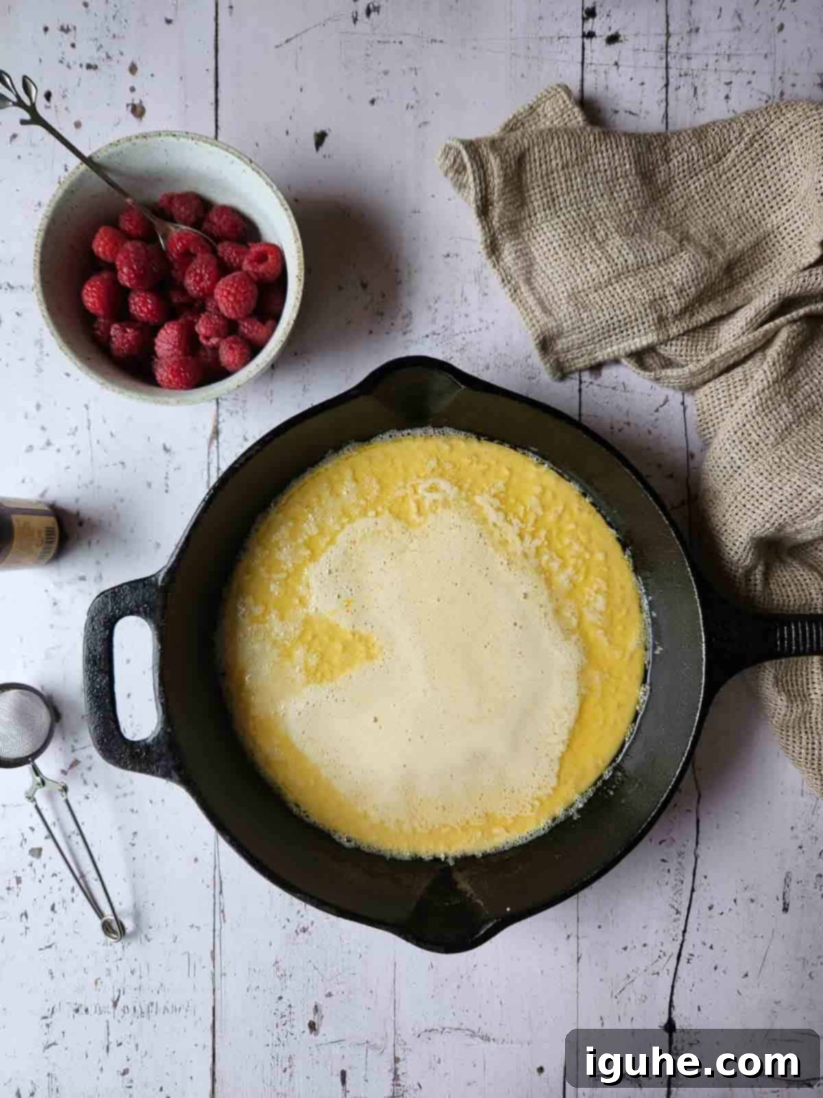 Vanilla Cloud Dutch Baby Pancake 6 Dutch baby batter poured into a hot cast iron skillet.