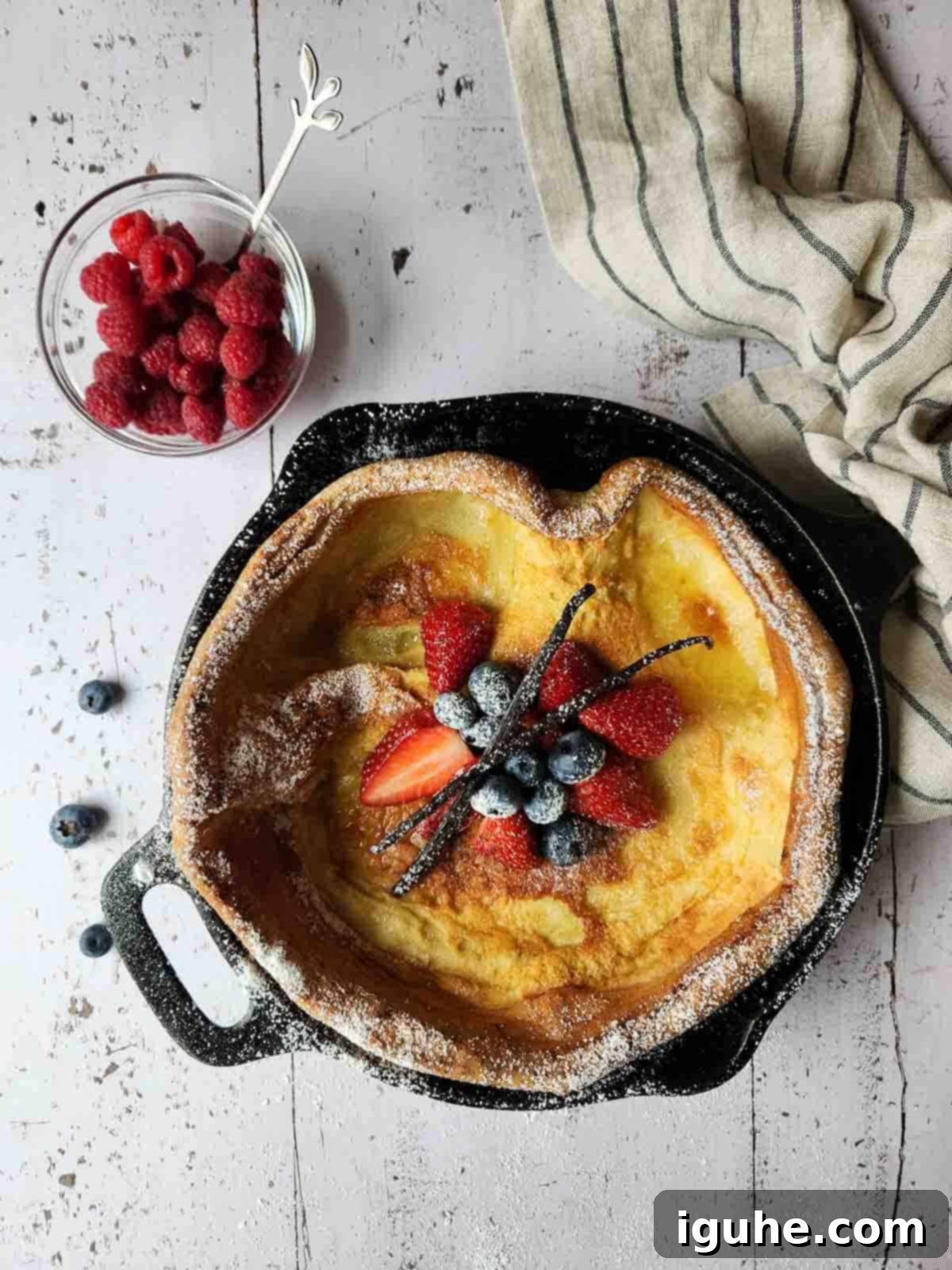 Vanilla Cloud Dutch Baby Pancake 7 Overhead of fruit toppings in the center of a Dutch baby.