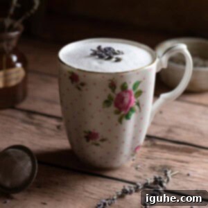 Lavender Bliss Latte 6 Lavender tea latte in a floral mug on top of a wood surface.
