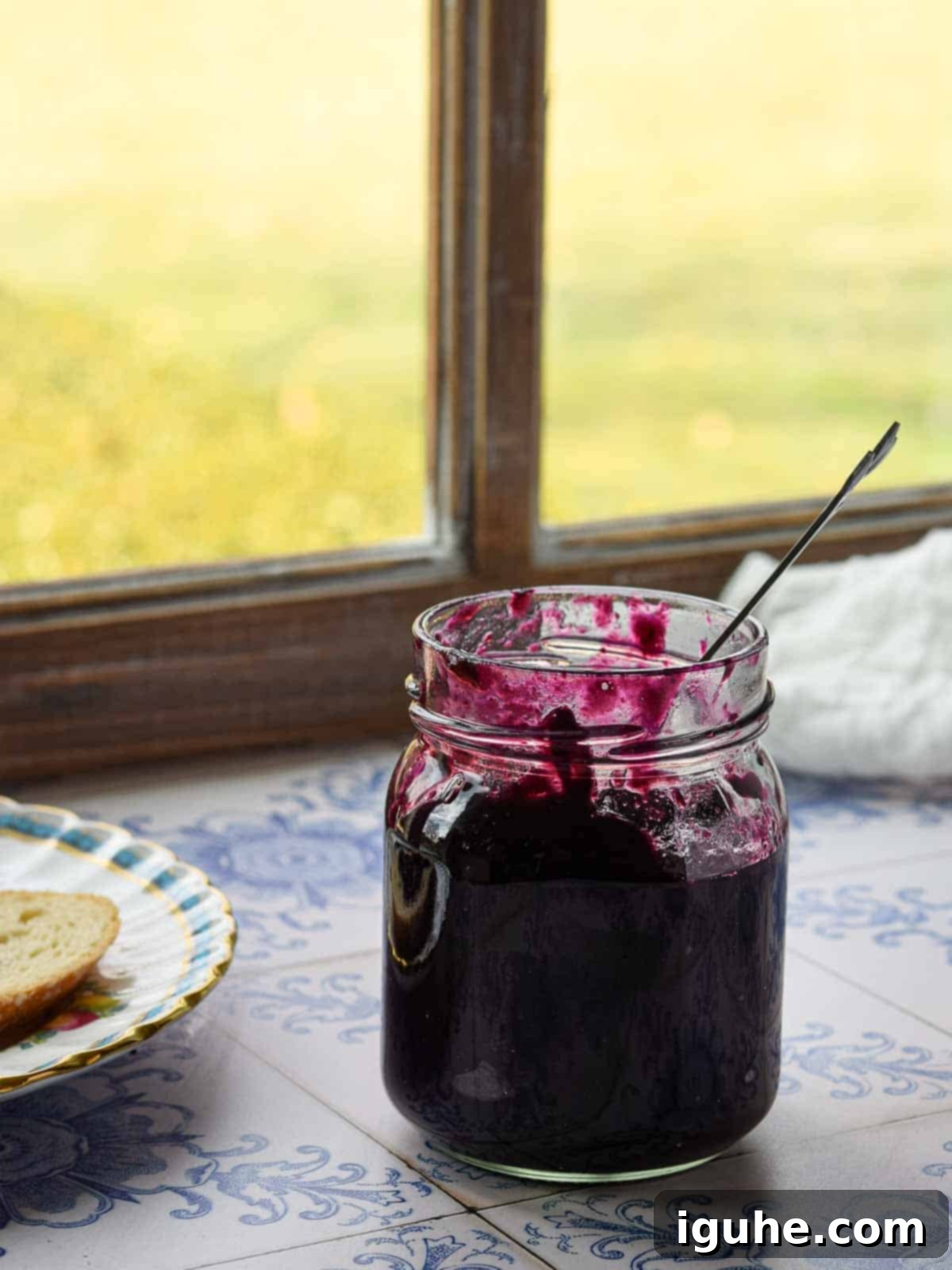 Blueberry Earl Grey Fridge Jam 3 Blueberry earl grey jam in a glass jar by the window with light coming in.