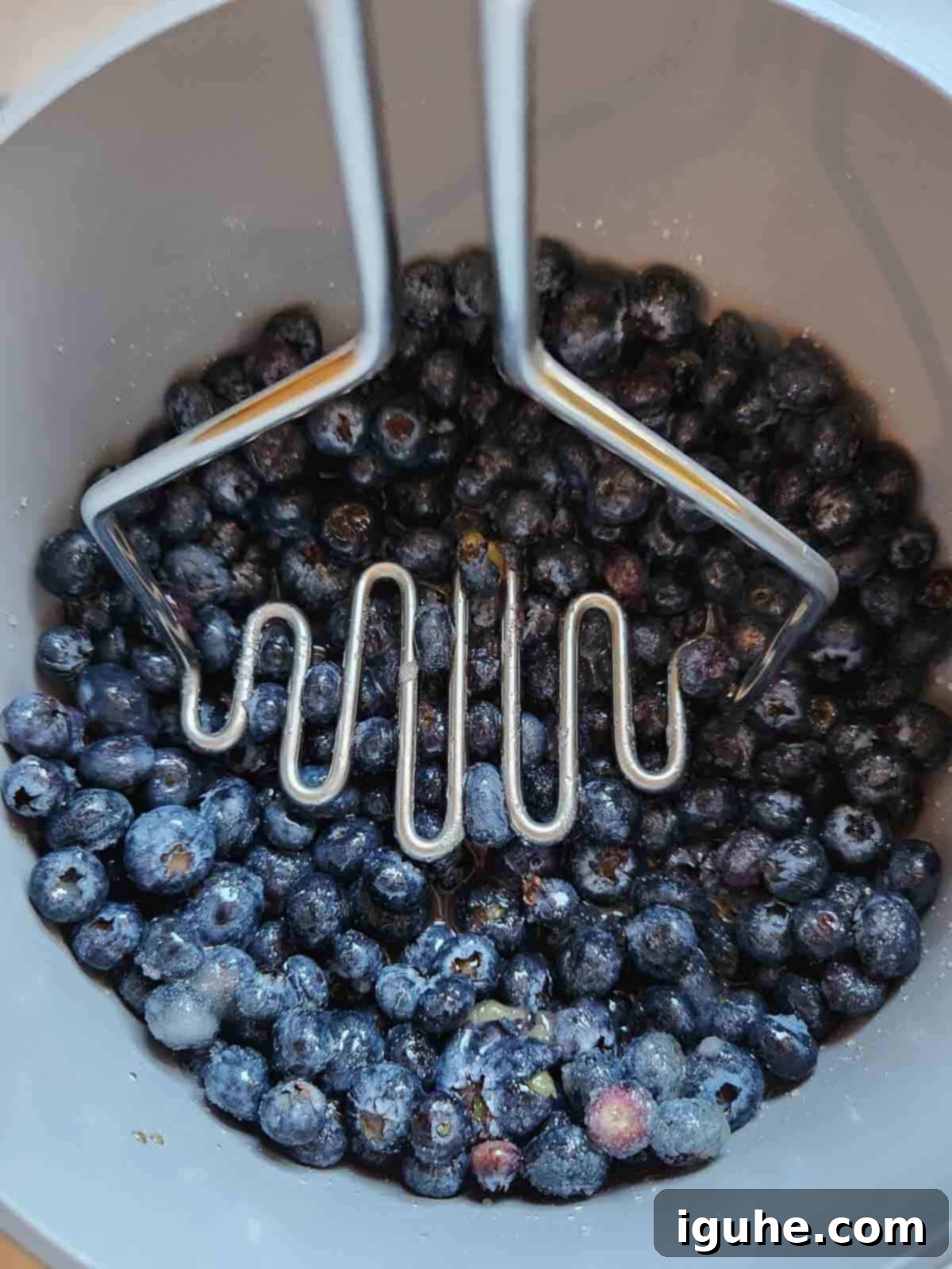 Blueberry Earl Grey Fridge Jam 4 Mashing blueberries and sugar in a pot for making jam.