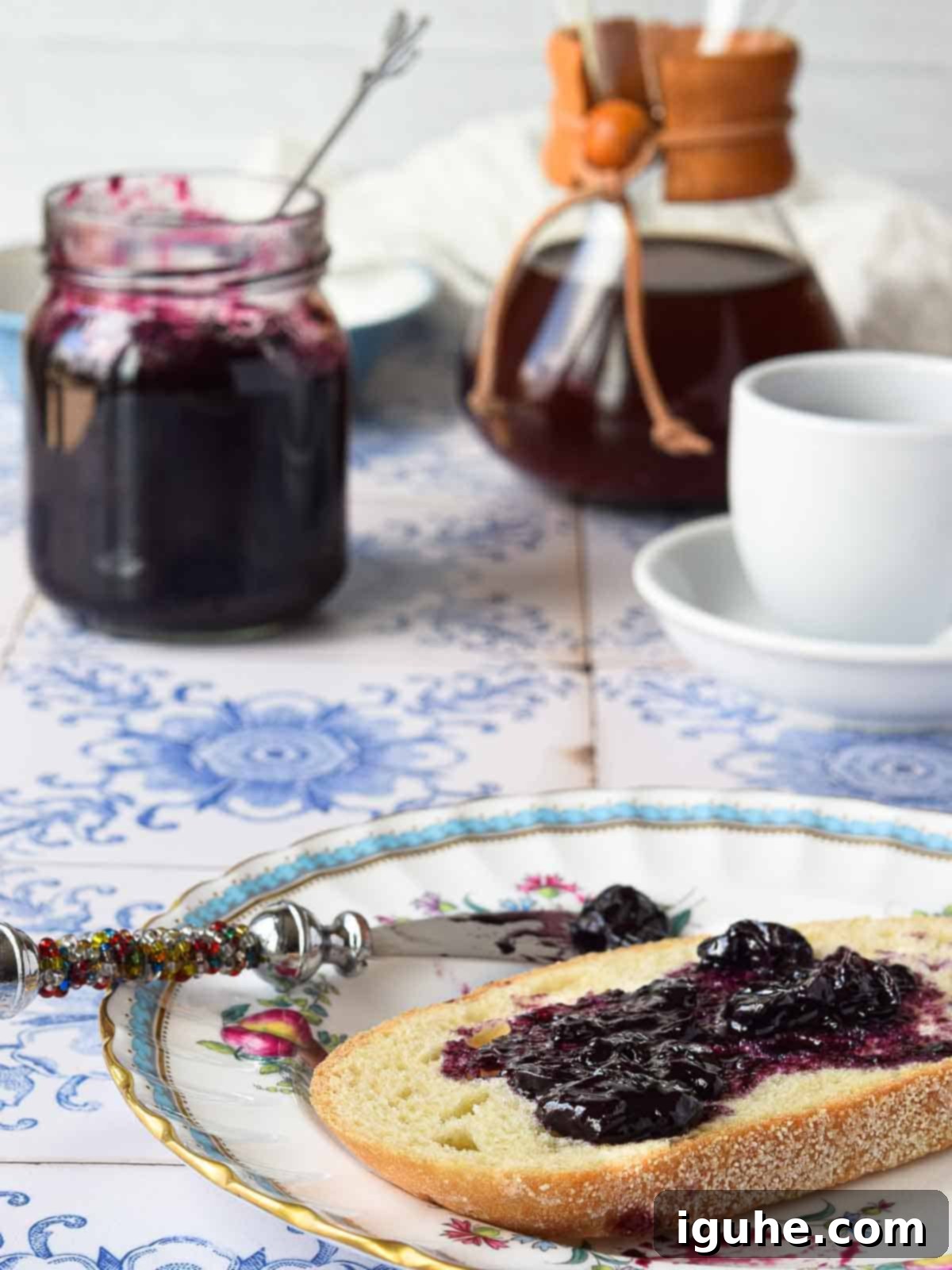 Blueberry Earl Grey Fridge Jam 8 Blueberry earl grey jam spread on toast with coffee in the background.