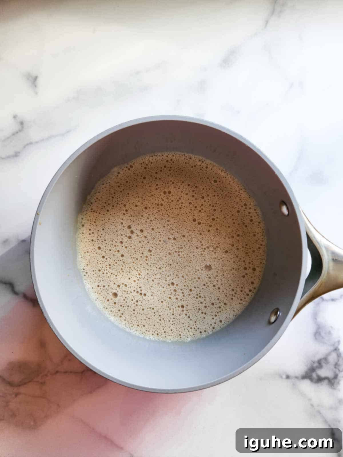 Velvet Espresso Panna Cotta 6 Espresso panna cotta mixture, now fully cooked with all ingredients dissolved, resting in the saucepan, showcasing its smooth, consistent texture.