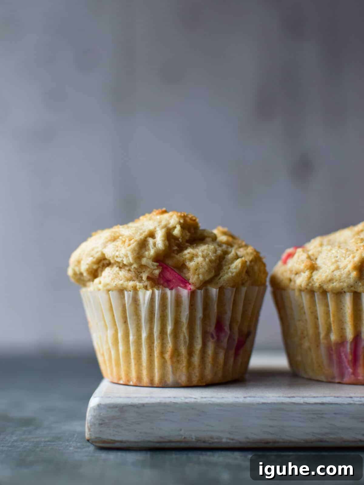 Tangy Rhubarb Muffins 9 Close-up of a muffin on a grey surface.