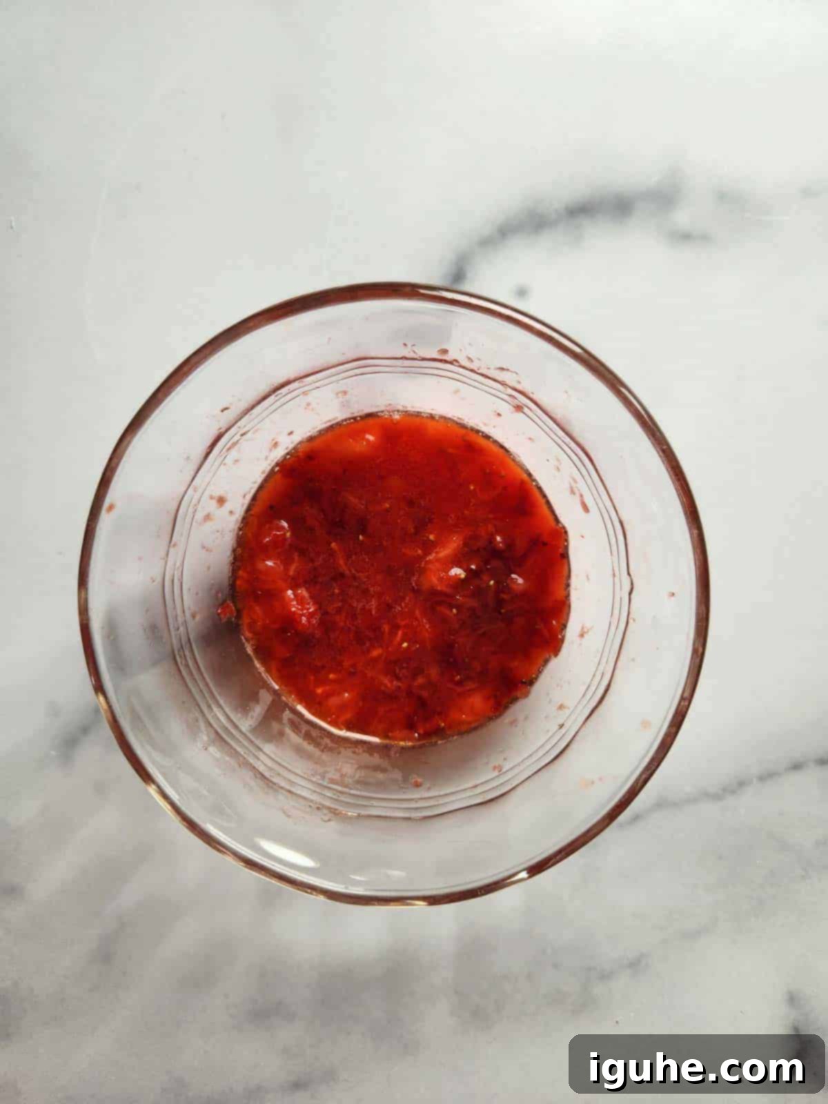 Strawberry Basil Cloud Butter 5 Clear bowl containing freshly mashed strawberries, ready to be incorporated into the whipped butter.
