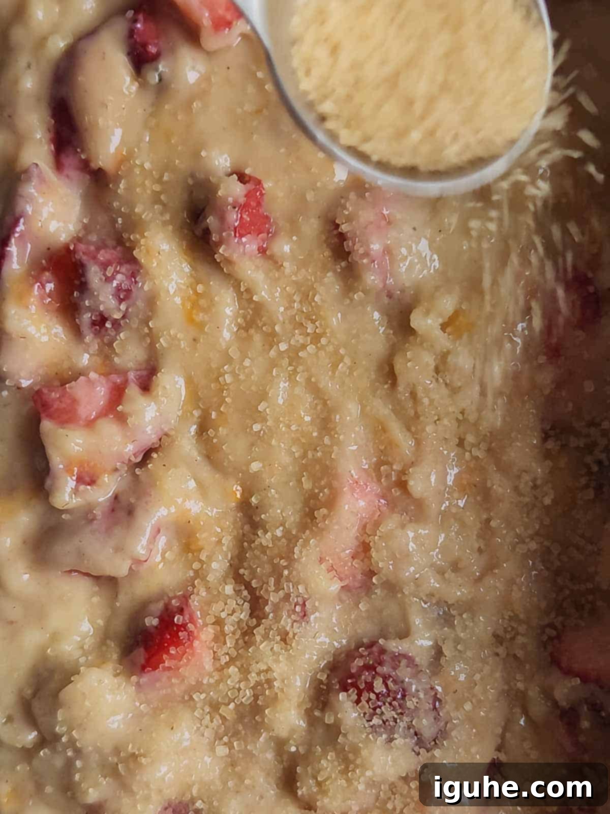 Buttermilk Kissed Strawberry Loaf 7 Turbinado sugar sprinkled on top of strawberry quick bread batter in a loaf pan.