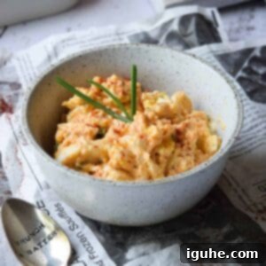 Smoky Paprika and Fresh Chive Egg Salad 9 Close up of egg salad with smoked paprika and chives in a bowl, highlighted by natural light.