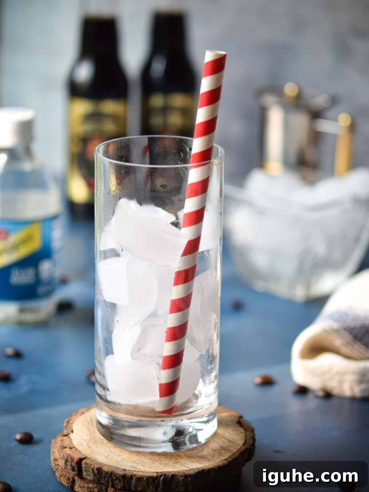 Espresso Sparkle 4 Clear glass filled with ice and a red straw, ready for the espresso soda ingredients.