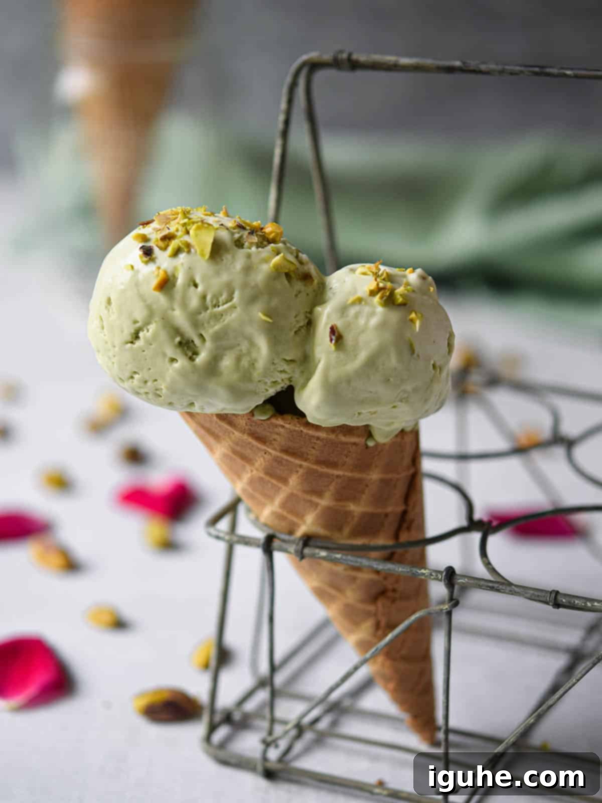Pistachio ice cream in a waffle cone, perfectly scooped and ready to enjoy.