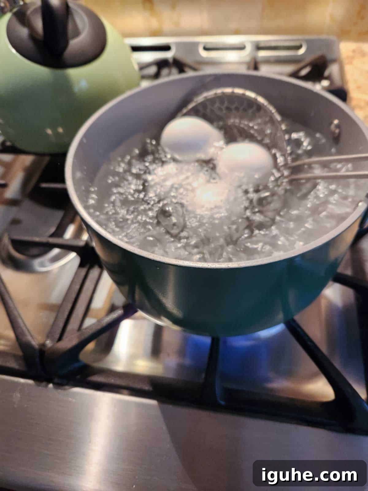 Sesame Kissed Jammy Eggs 5 Eggs being placed in a pot of boiling water.