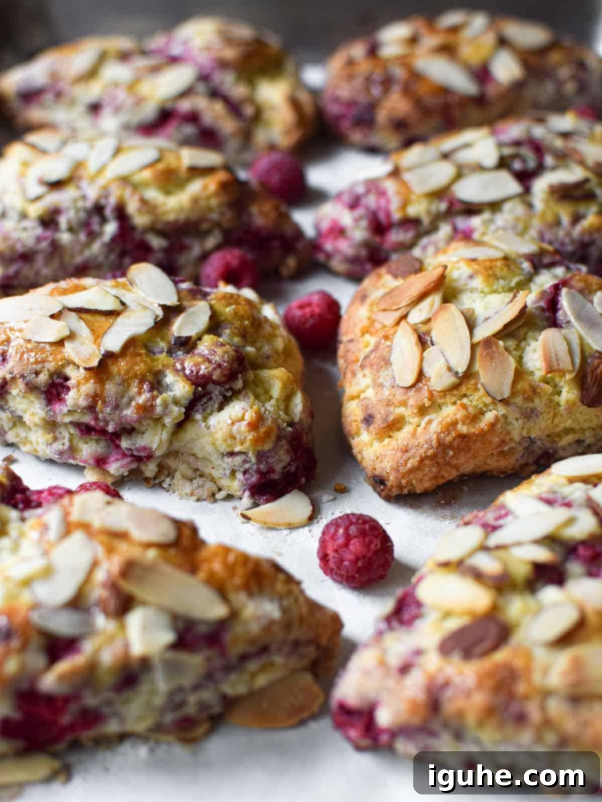 Beautifully baked raspberry almond scones on a baking pan, ready to be enjoyed.