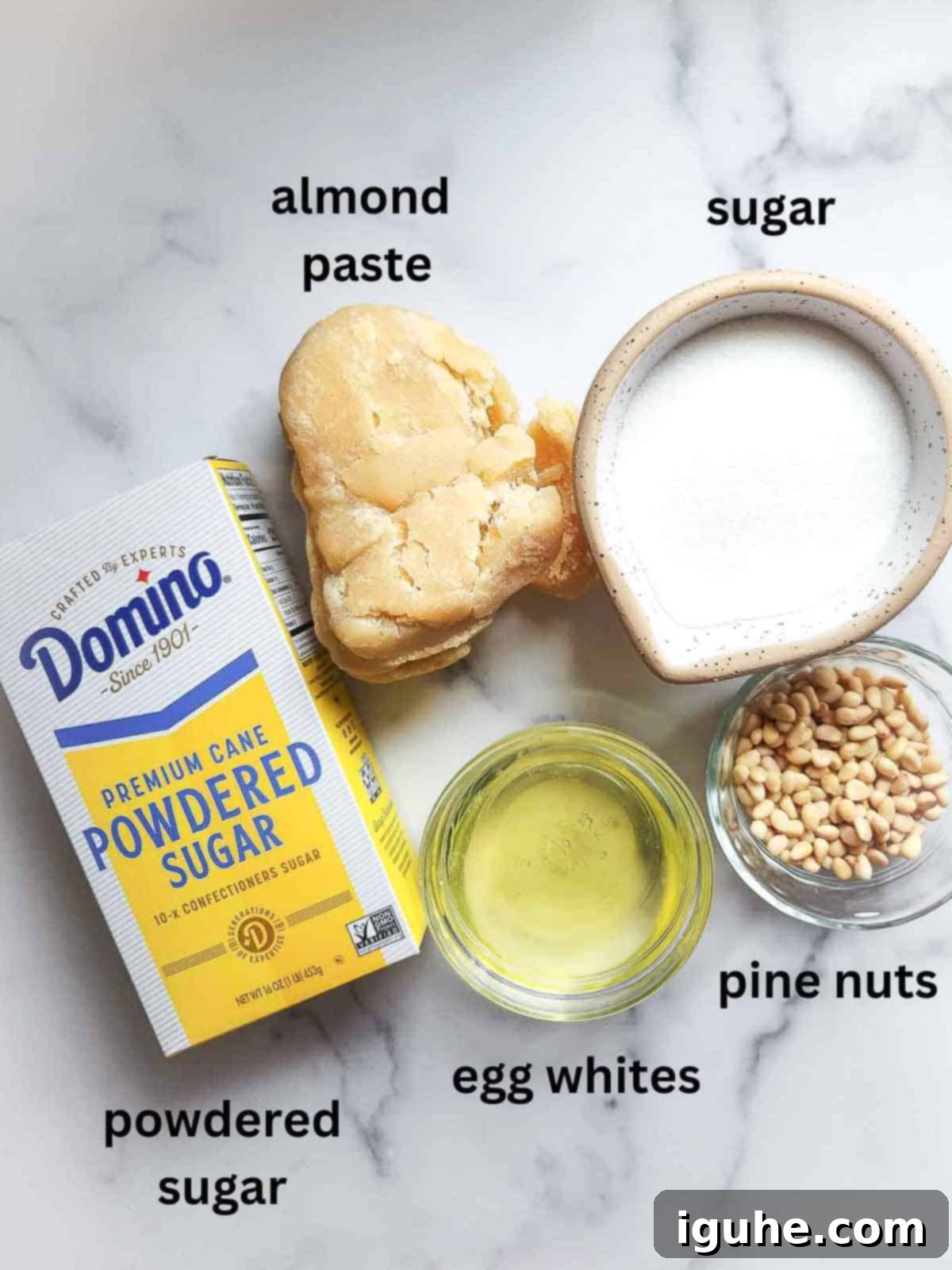 The Easiest Italian Pignoli Cookies 3 Ingredients for Italian pignoli cookies on a marble surface.