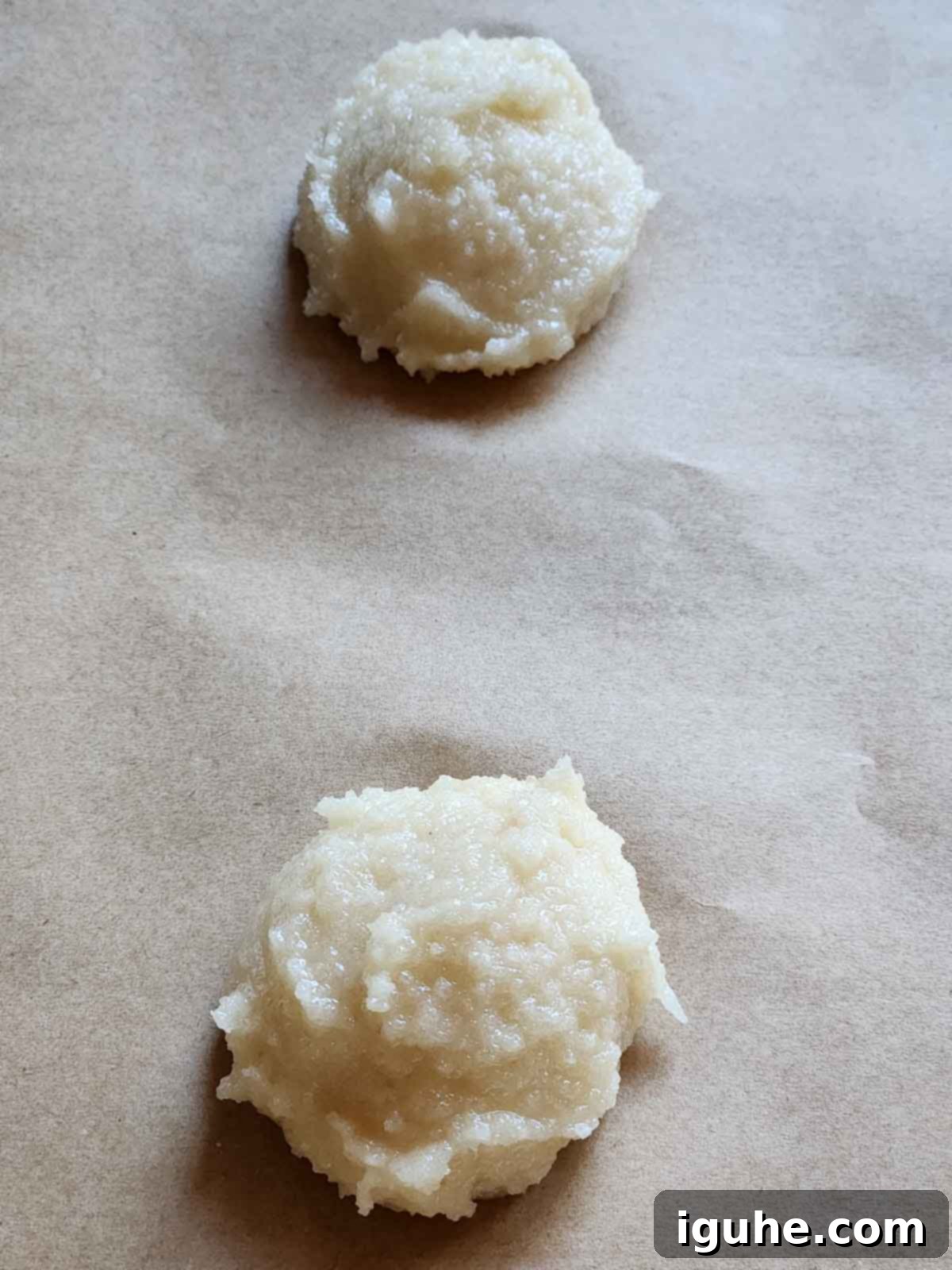 The Easiest Italian Pignoli Cookies 5 Scoops of cookie batter on parchment paper.