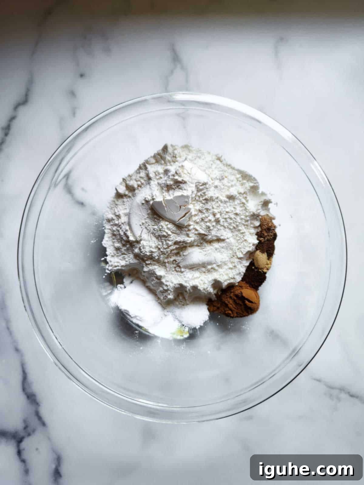 Warm Spiced Pumpkin Bread with Maple Cream Cheese Frosting 4 Dry ingredients in a clear bowl for pumpkin bread.