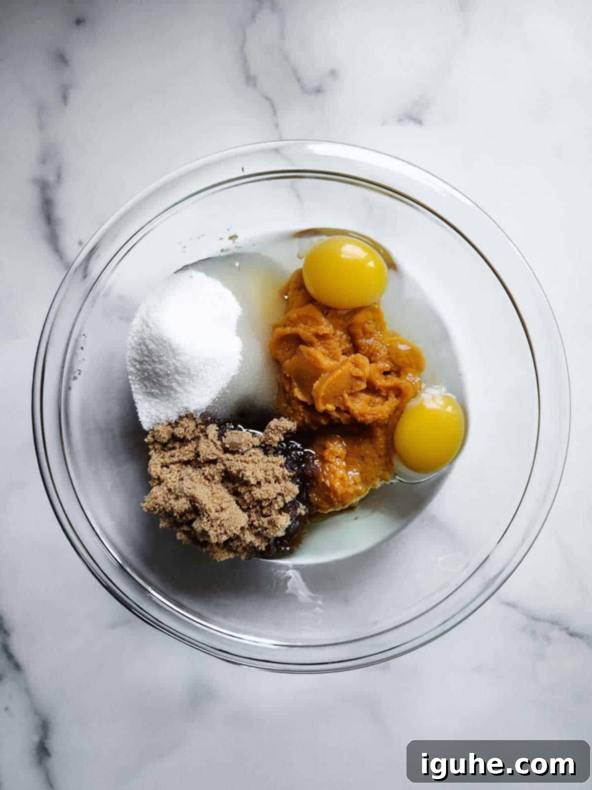 Warm Spiced Pumpkin Bread with Maple Cream Cheese Frosting 5 Wet ingredients in a clear bowl for pumpkin bread.