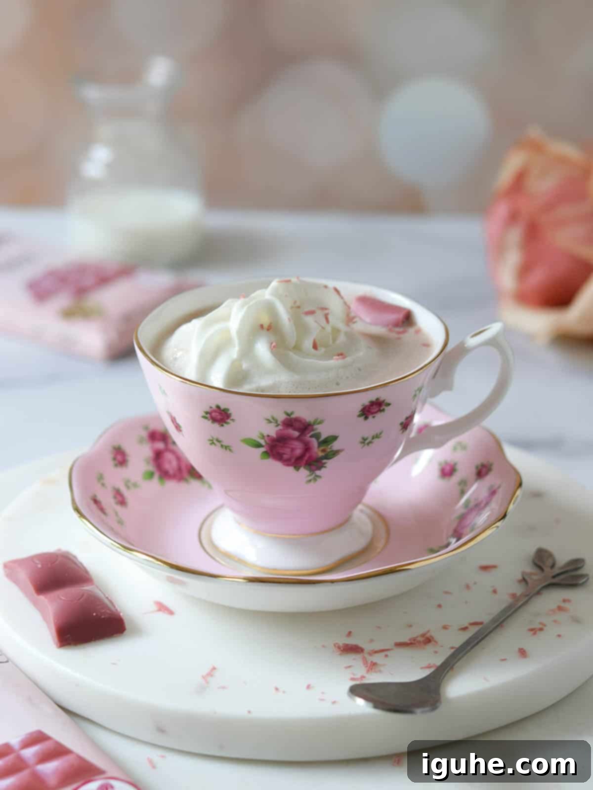 Ruby hot chocolate in a pink mug with whipped cream on top, ready to be enjoyed.