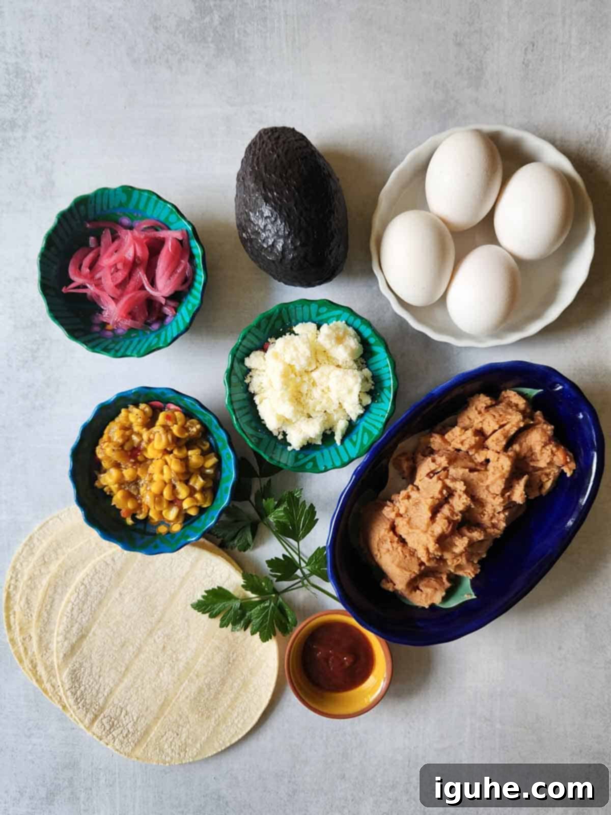 Quick and Delicious Huevos Rancheros Tostadas 3 Overhead of ingredients in bowls for Mexican tostadas.