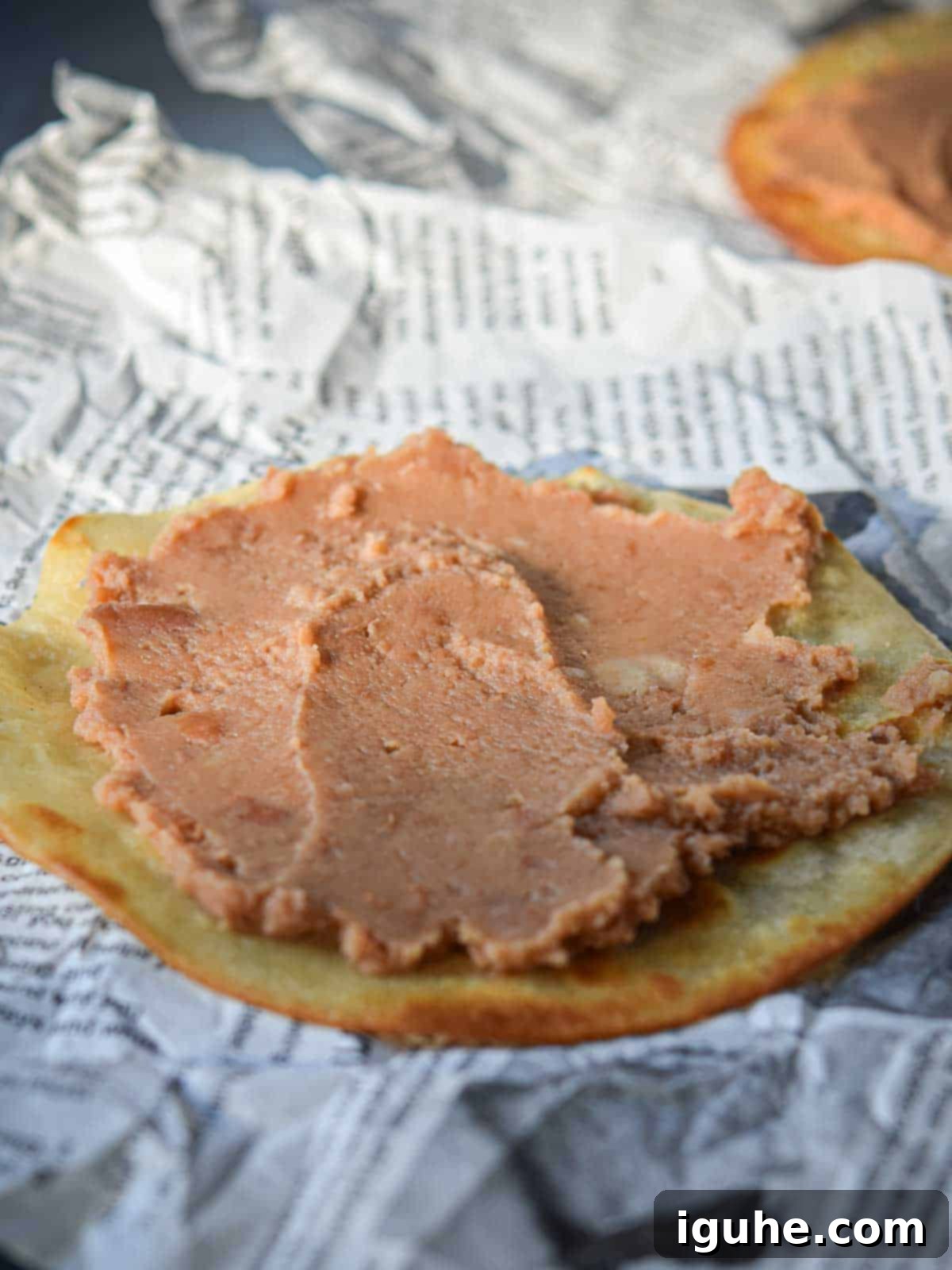 Quick and Delicious Huevos Rancheros Tostadas 6 Fried tortilla with refried beans spread on top of it.