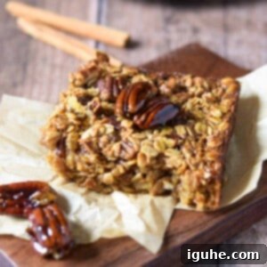 Decadent Pecan Pie Baked Oatmeal 10 Baked pecan pie oatmeal on a wood slab with cinnamon sticks in the background, ready to be served.