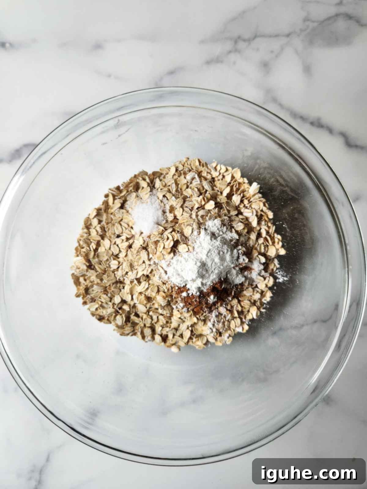 Decadent Pecan Pie Baked Oatmeal 4 Dry ingredients for pecan pie baked oatmeal, including oats, cinnamon, and baking powder.